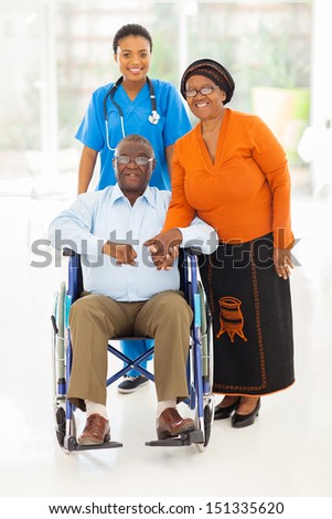 portrait of african female healthcare worker with senior couple at home