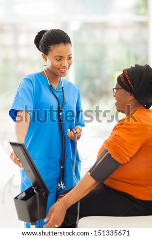 beautiful african medical nurse and senior patient in office