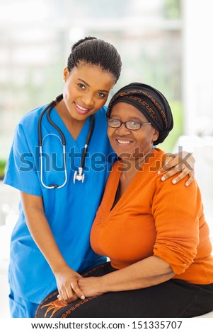 Friendly Caring Young African Nurse And Senior Patient