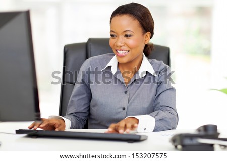 beautiful young african american businesswoman working on computer
