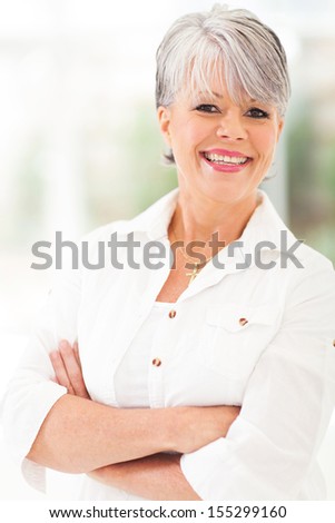 cheerful middle aged woman with arms folded