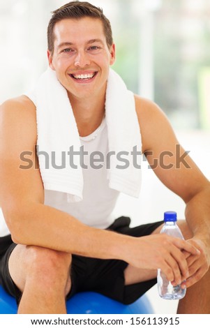 portrait of handsome man after exercising in gym