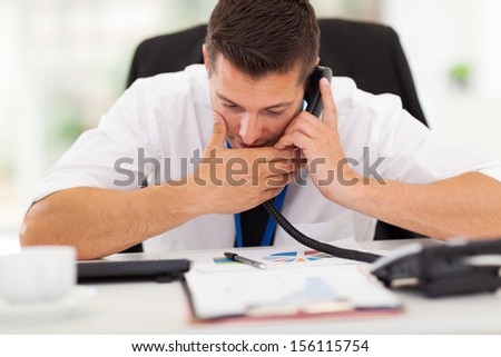 office worker making a private call with a company phone