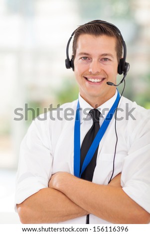 portrait of happy call center customer service worker with arms crossed