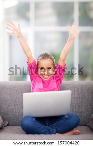 happy little girl with new laptop computer