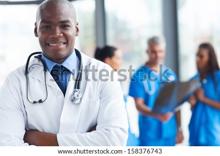 smart african medical surgeon with arms crossed