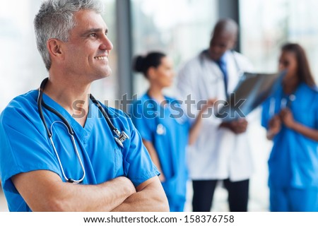 Portrait Of Confident Senior Medical Doctor In Hospital