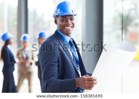 handsome african construction engineer with blue print