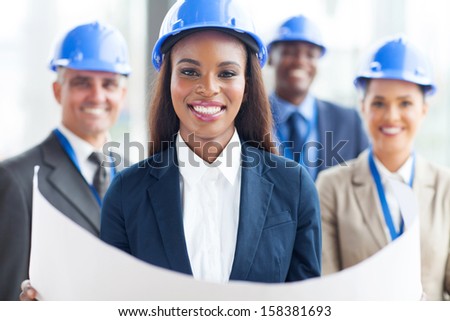 happy african american female architect with team on background