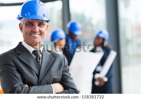portrait of senior construction manager with arms crossed