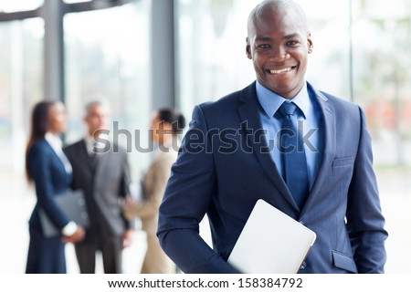 Handsome African American Businessman With Laptop Computer In Office