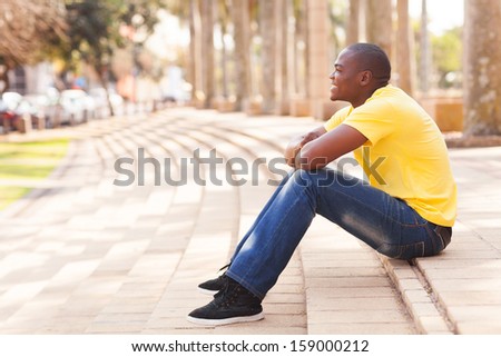 side view of african man relaxing in urban city