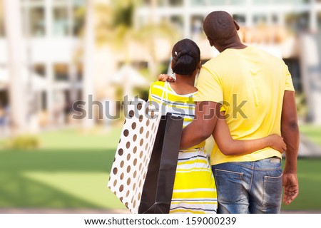 Rear View Of Young African Couple Looking At Modern Apartment Before Buying