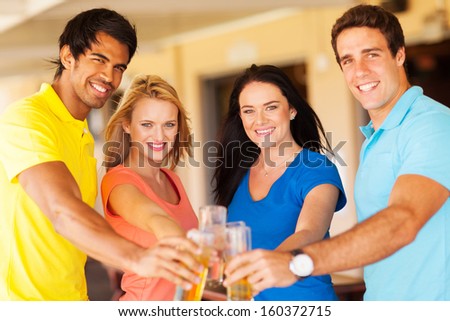 group of happy friends having drinks at a party
