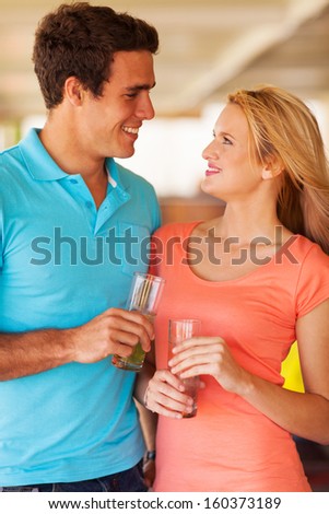 beautiful young couple hanging out at the bar having drinks
