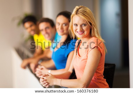 beautiful female university student with group of friends