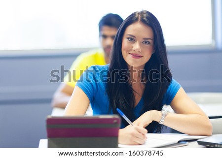 portrait of beautiful female college student in lecture room