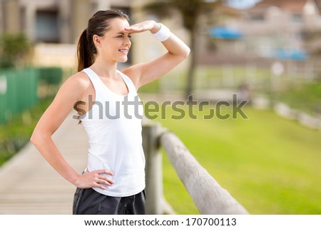 beautiful young exercise woman outdoors and looking into distance