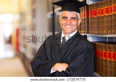 portrait of senior graduate with arms crossed in library