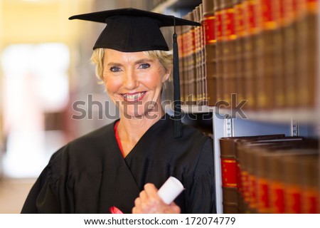 elegant middle aged female law school graduate in library
