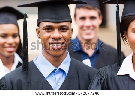 portrait of young college graduates in graduation gown