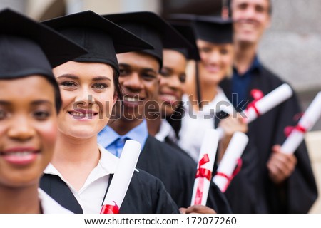 Group Of Happy College Graduates Standing In A Row