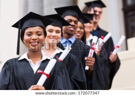 happy group of university graduates at graduation ceremony