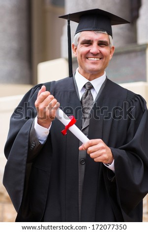 smiling middle aged male graduate in front university building