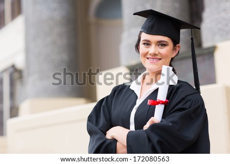 portrait of female college student holding graduation certificate