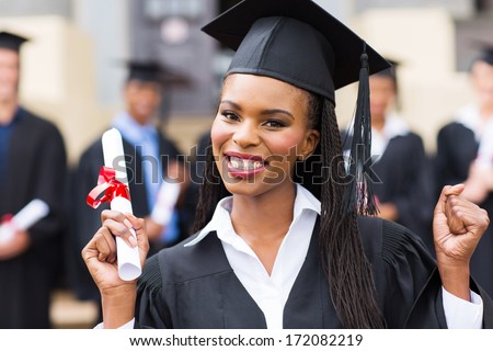 happy african american female graduate at university graduation ceremony