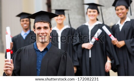 handsome male university graduate holding his diploma