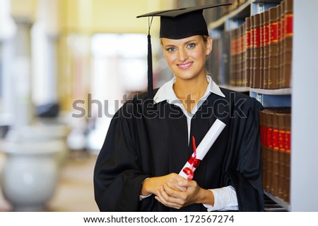 portrait of pretty female law school graduate in library