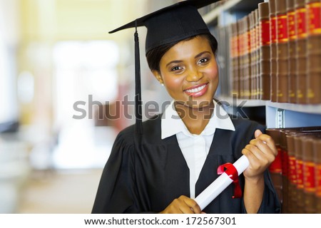 pretty female african college graduate in library pretty female african college graduate in library