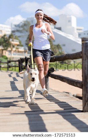 happy woman jogging with her dog