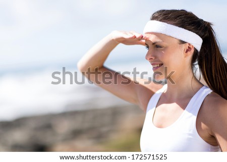 close up portrait of attractive fitness woman looking into distance