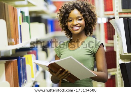 smiling female african american student in university library