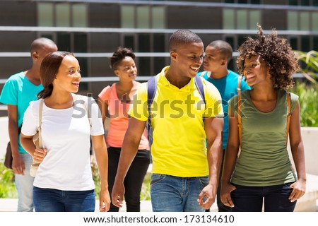 happy african american college students walking together on campus