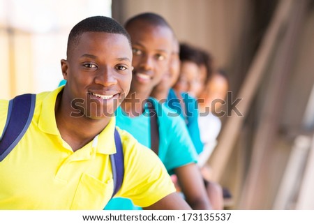 handsome male african student with friends
