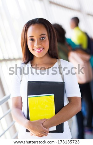 cute female african american college student holding books