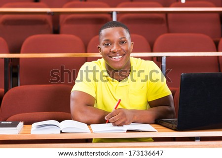 happy male african american college student in lecture room