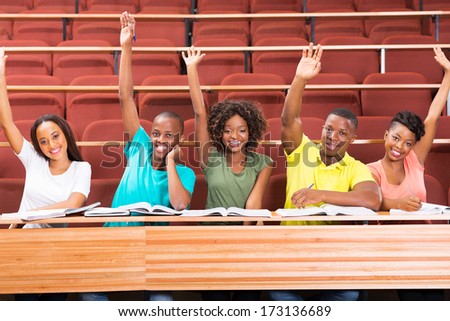 group of african uni students arms up in classroom