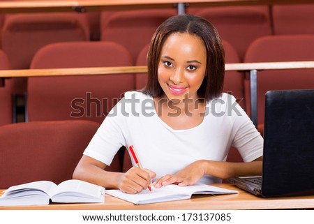 portrait of young female african college student studying in lecture hall