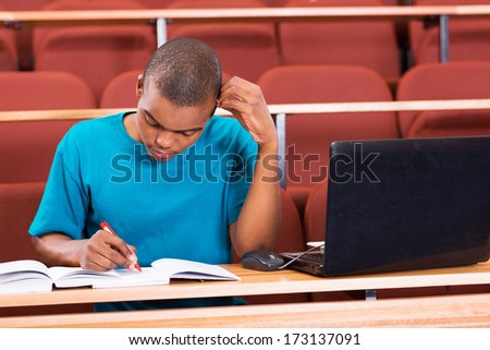 young african american college student studying in lecture hall