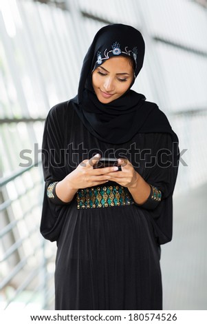 modern muslim woman reading email no smart phone