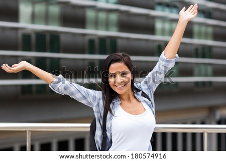excited young female college student on campus
