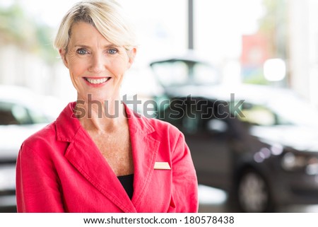 beautiful senior woman working at car dealership