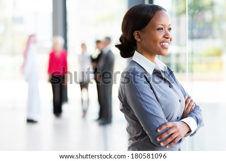 attractive black businesswoman looking outside window