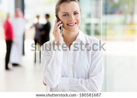 portrait of young corporate worker talking on cell phone