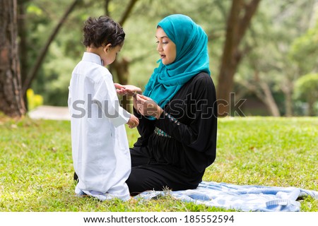 Arabian mother playing with little boy outdoors Arabian mother playing with little boy outdoors