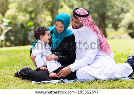 cheerful muslim family sitting outdoors